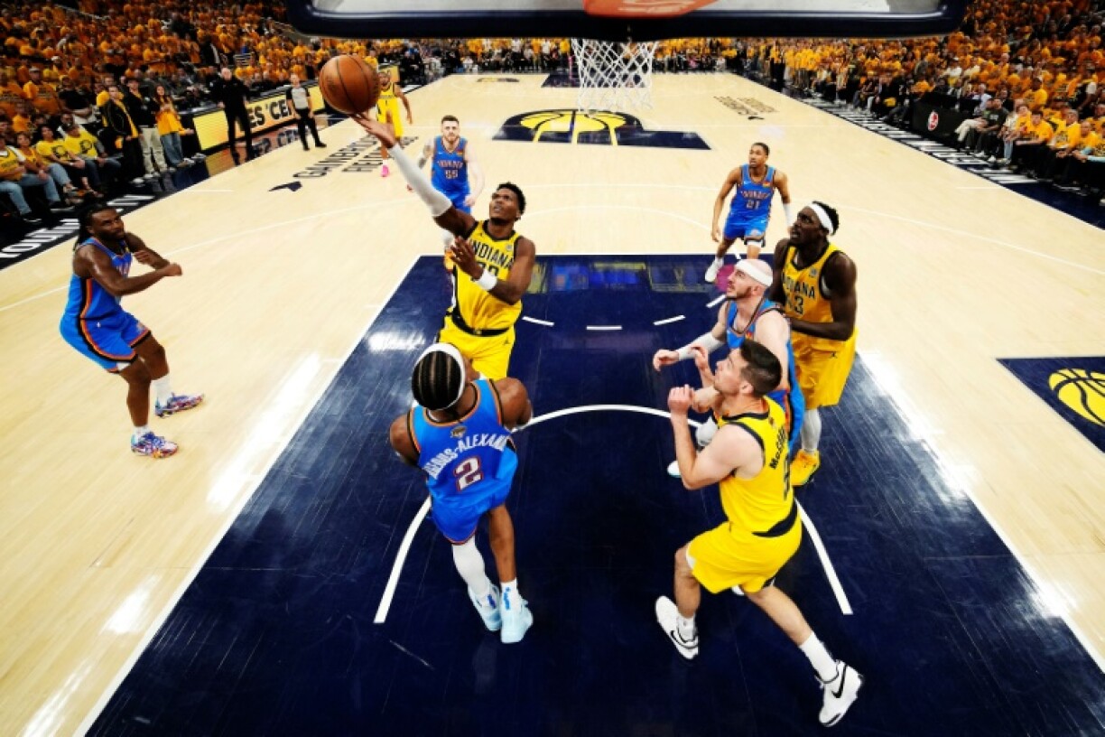 Bennedict Mathurin of the Indiana Pacers shoots the ball over Oklahoma City's Shai Gilgeous-Alexander in game three of the NBA Finals