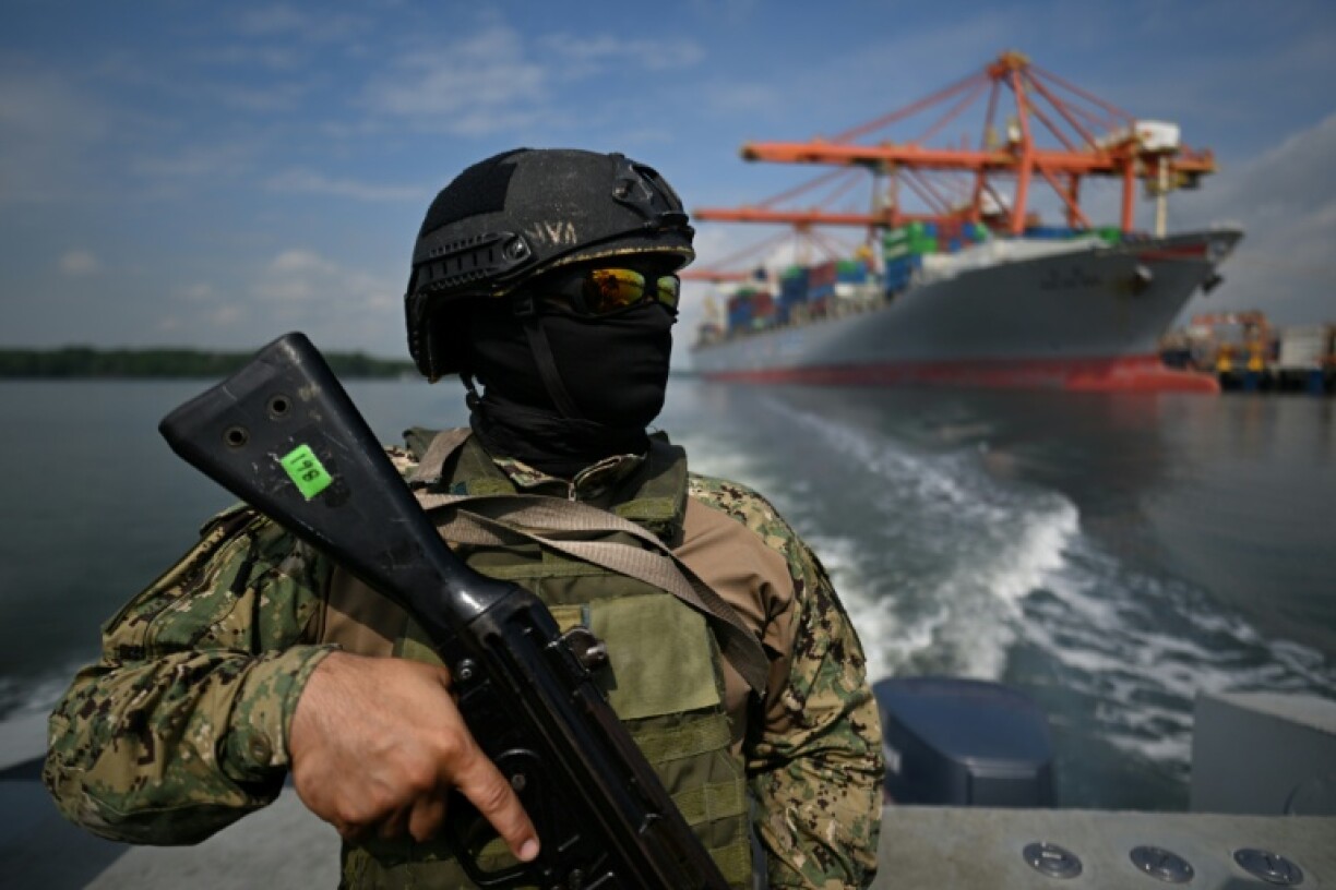 A member of the Ecuadoran Navy conducts a security and surveillance patrol in the port of Guayaquil