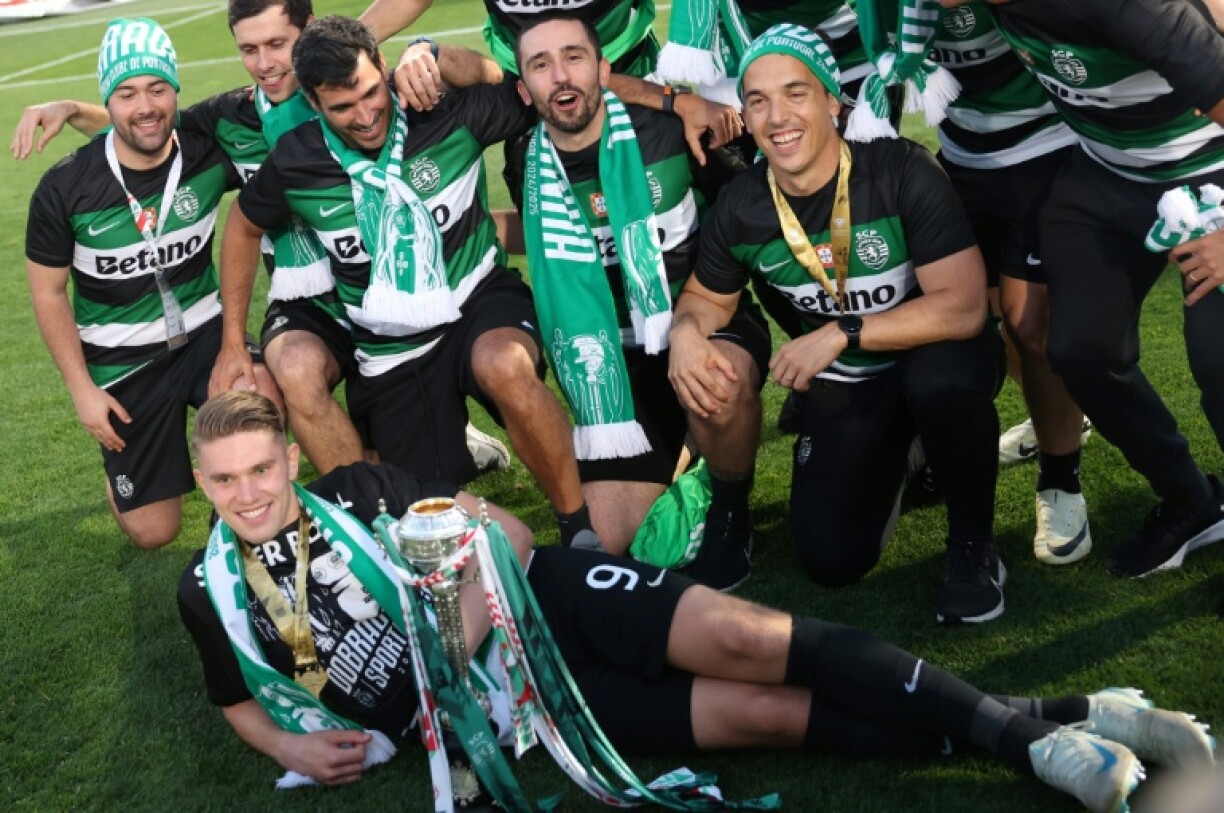 Sporting Lisbon's Swedish forward Viktor Gyokeres celebrates with the trophy and his team-mates