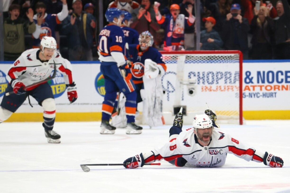 Alex Ovechkin slides along the ice in celebration after scoring his record 895th goal