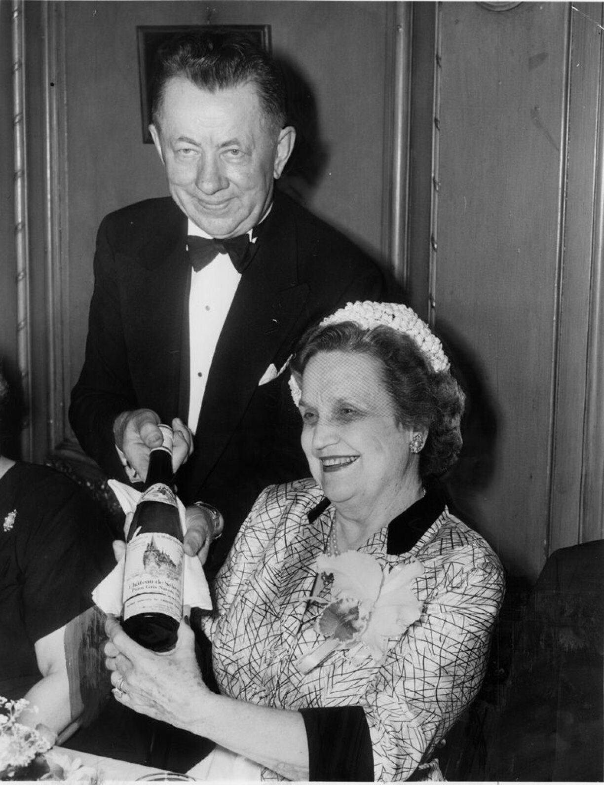 Teddy Majerus with US Ambassador to Luxembourg Perle Mesta at L'Aiglon with a bottle of wine from Schengen, Luxembourg.