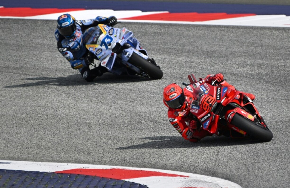 Marc Marquez (R) leads his brother Alex Marquez on his way to victory in the sprint at the Austrian MotoGP