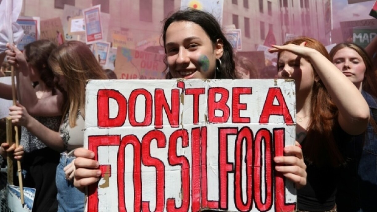 Student and youth climate activists with placards march through central London on May 24, 2019 demanding action to tackle climate change