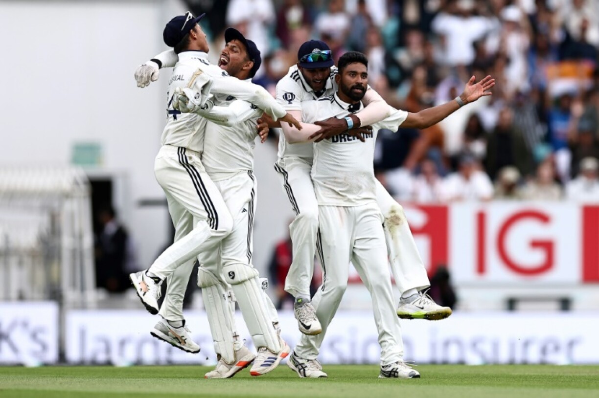 Mohammed Siraj (R) celebrates taking the wicket of England's Gus Atkinson as India win the fifth Test at the Oval by six runs