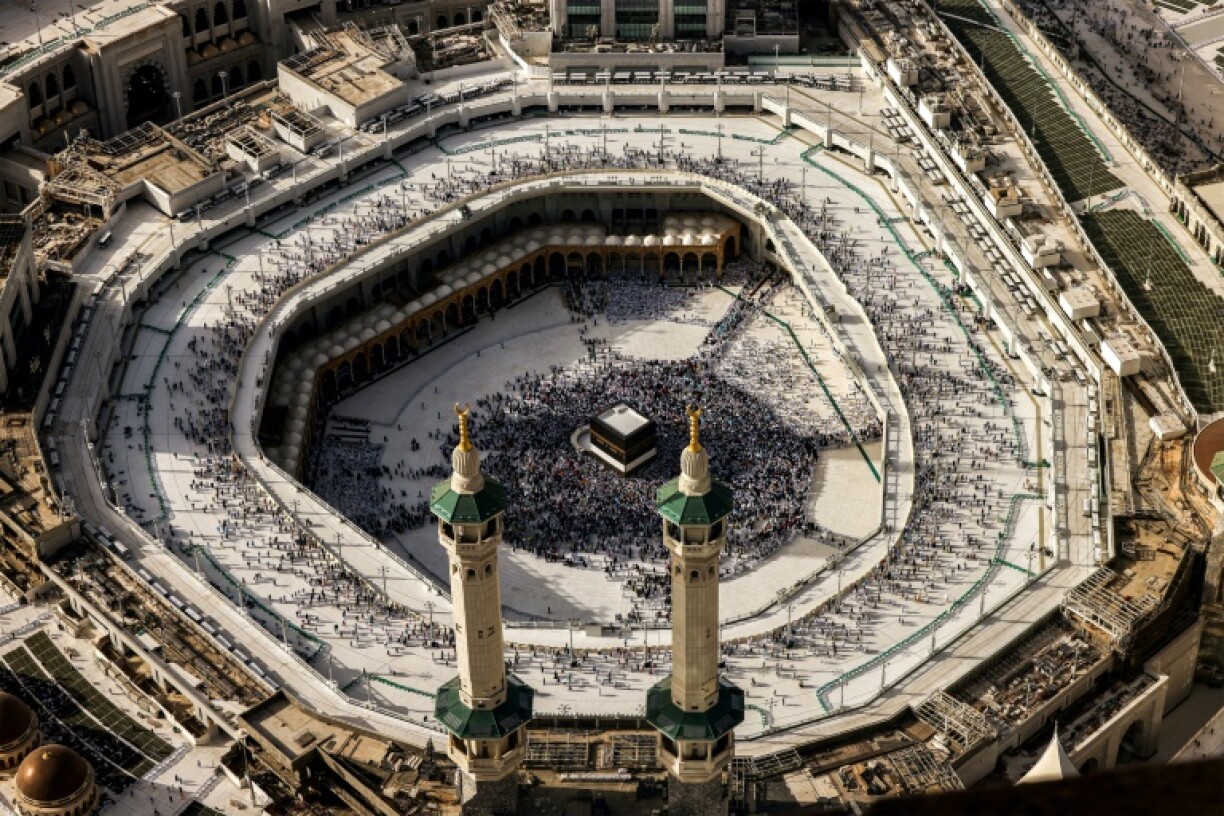 Muslim worshippers gather around the Kaaba, Islam's holiest shrine, at the Grand Mosque complex in the holy city of Mecca