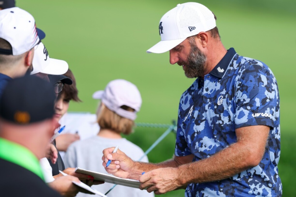 Two-time major winner Dustin Johnson signs autographs for fans during a practice session ahead of the 125th US Open at Oakmont, where he won his first major crown in 2016