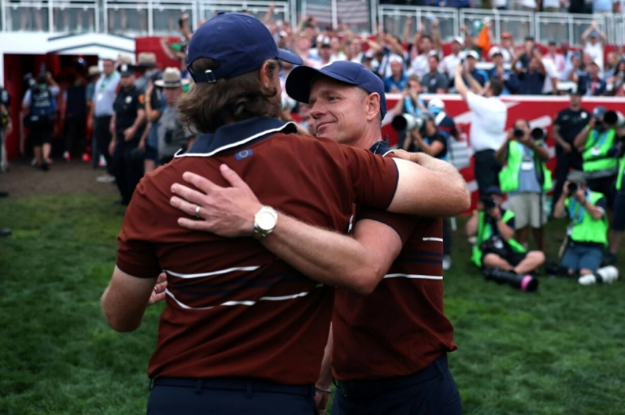 Europe captain Luke Donald hugs Tommy Fleetwood after Europe won three of four four-ball matches on day two of the Ryder Cup