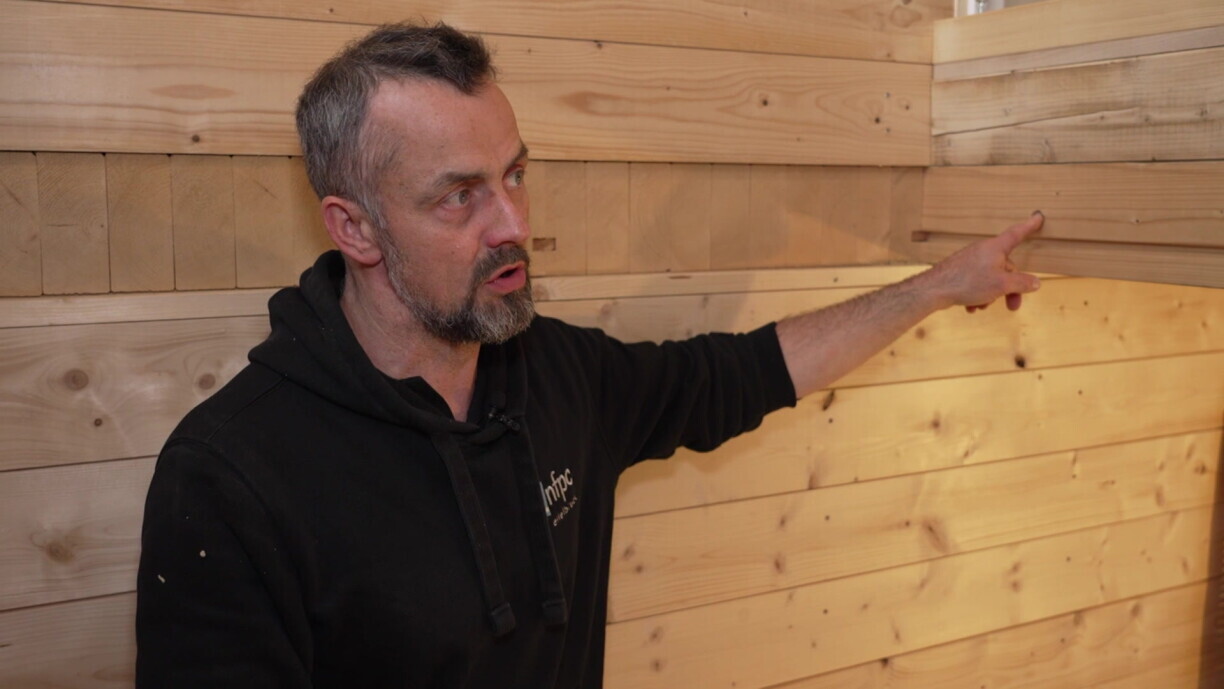 De Marc Neu weist op eng vun den Dunnen aus Holz, déi een am Haus gesäit.