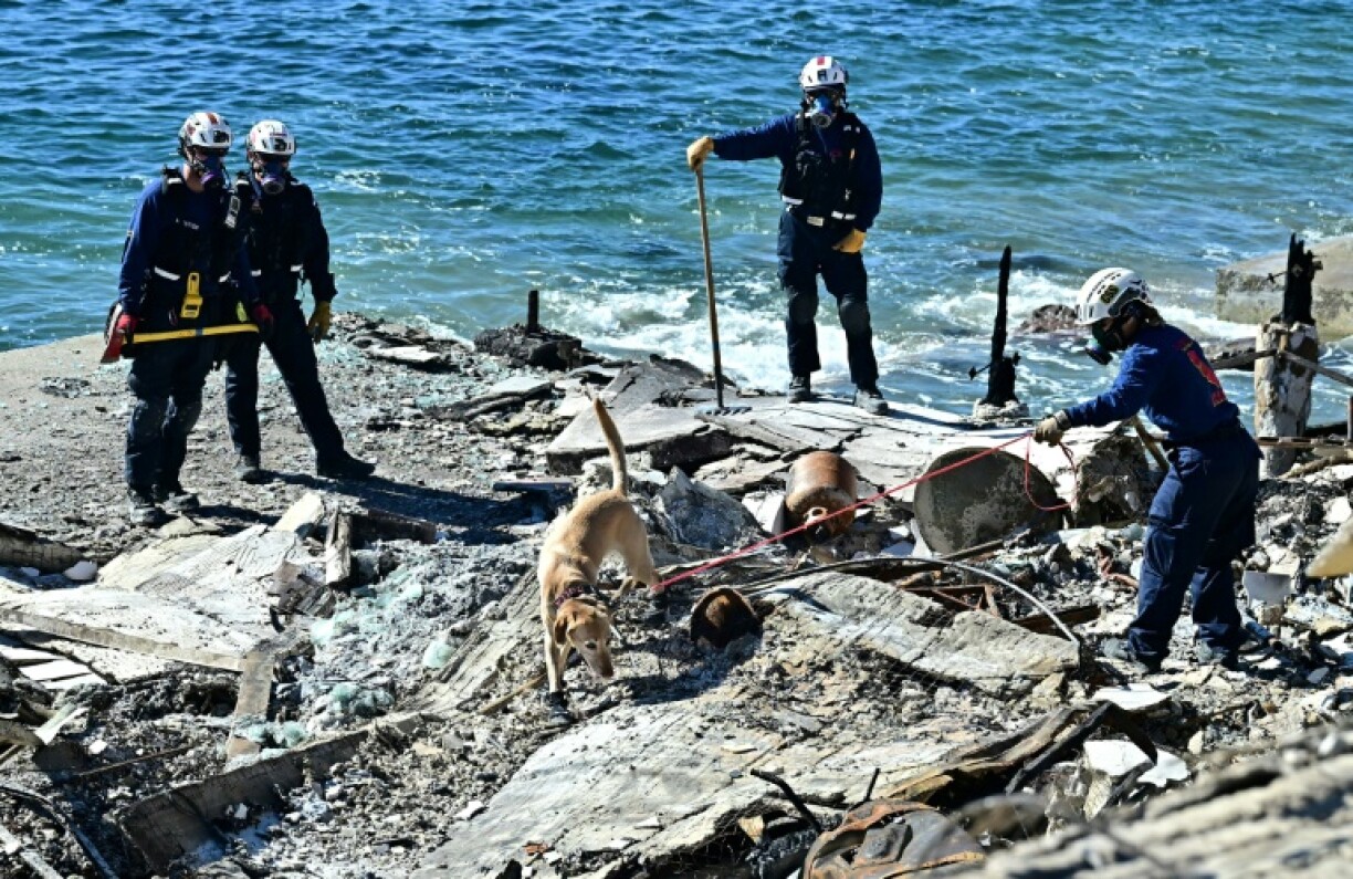 Emergency officials on Sunday were continuing to survey the damage, going house-to-house in search of further human remains, and beginning in earnest the daunting challenge of clearing endless tons of debris