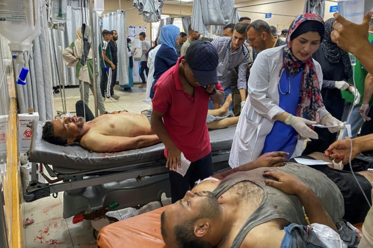 Palestinians who were injured in Israeli fire as they gathered near a food aid centre, receive care at Khan Yunis' Nasser hospital