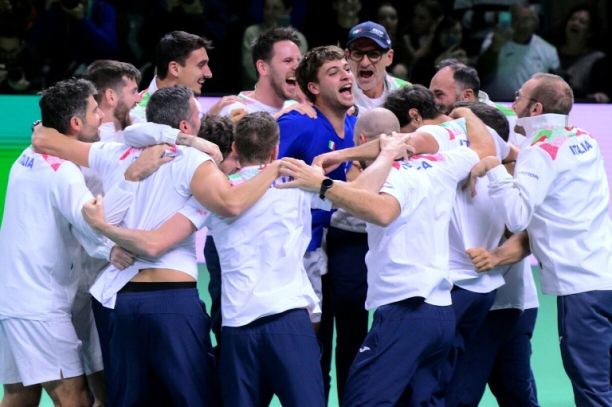 Flavio Cobolli (C) is mobbed by his team-mates after sealing another Davis Cup triumph for Italy