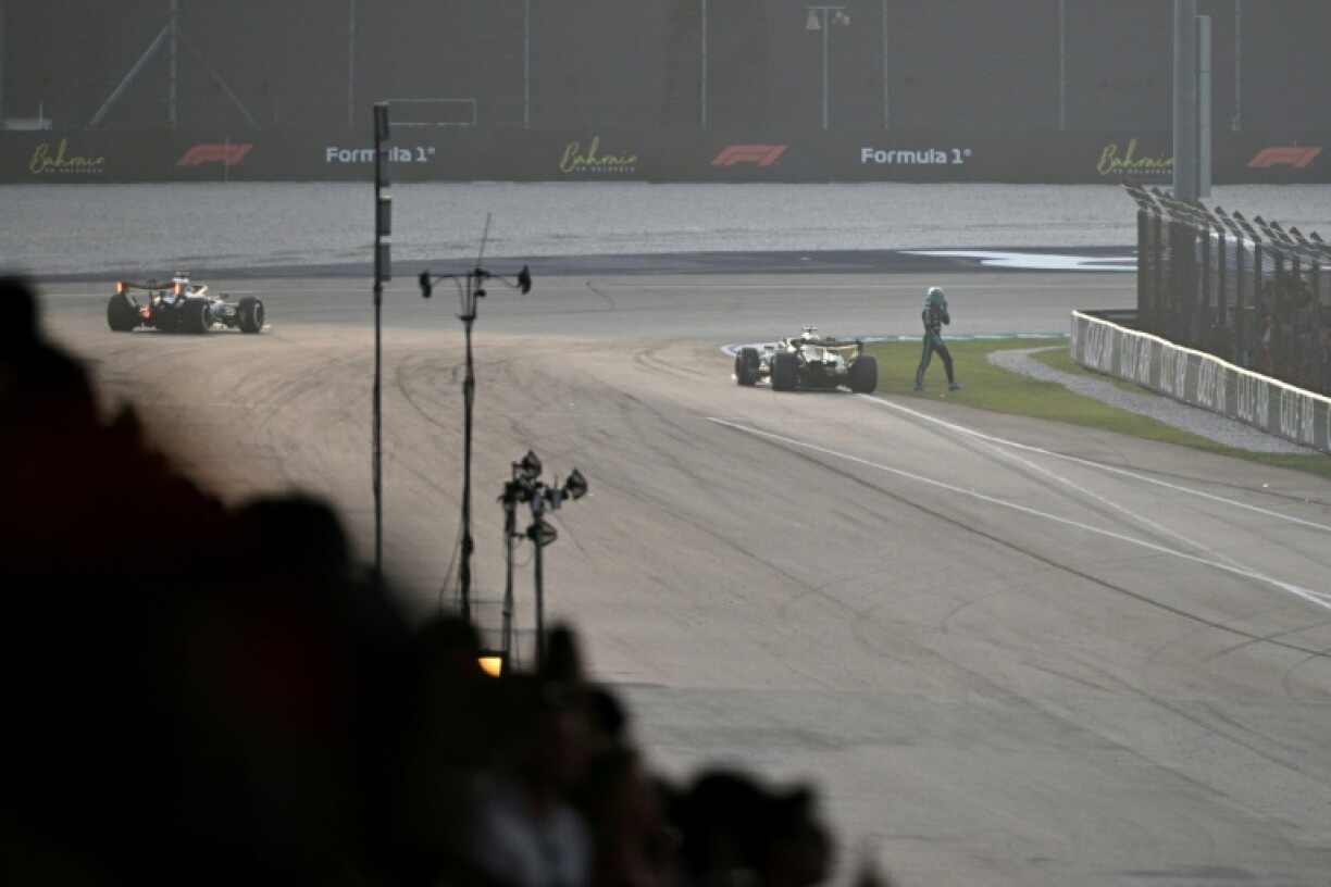 George Russell trudges away from his stalled Mercedes
