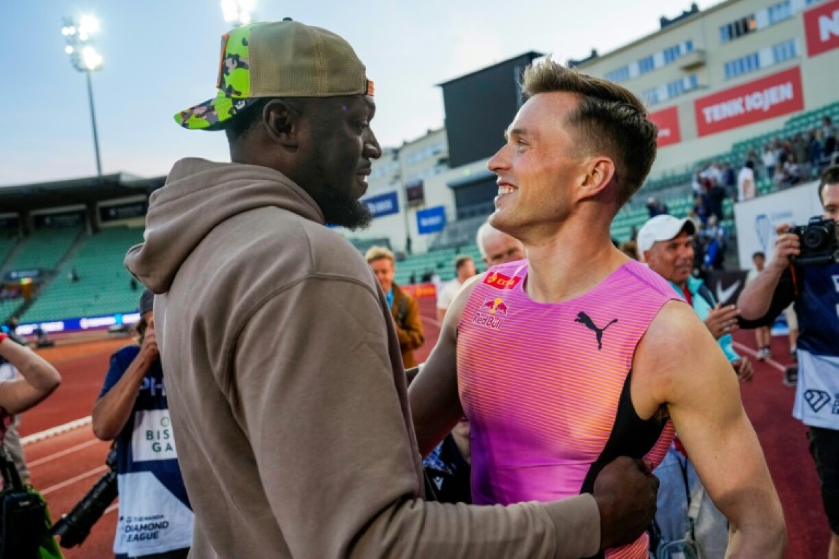 Norway's Karsten Warholm (R) speaks with Jamaican sprint legend Usain Bolt