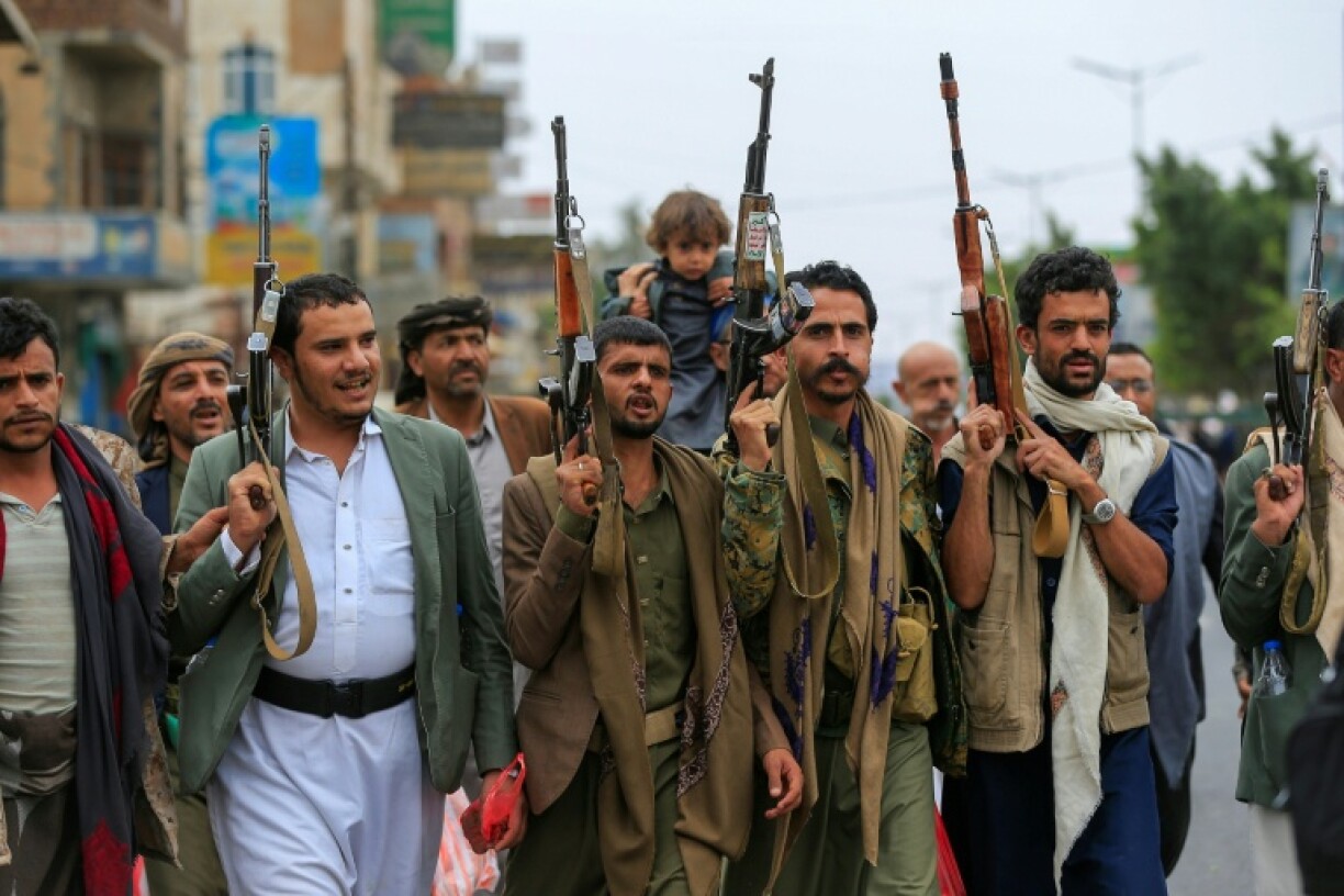 Yemenis brandish their rifles as they chant anti-Israel and anti-US slogans during a rally in the Huthi-run capital Sanaa