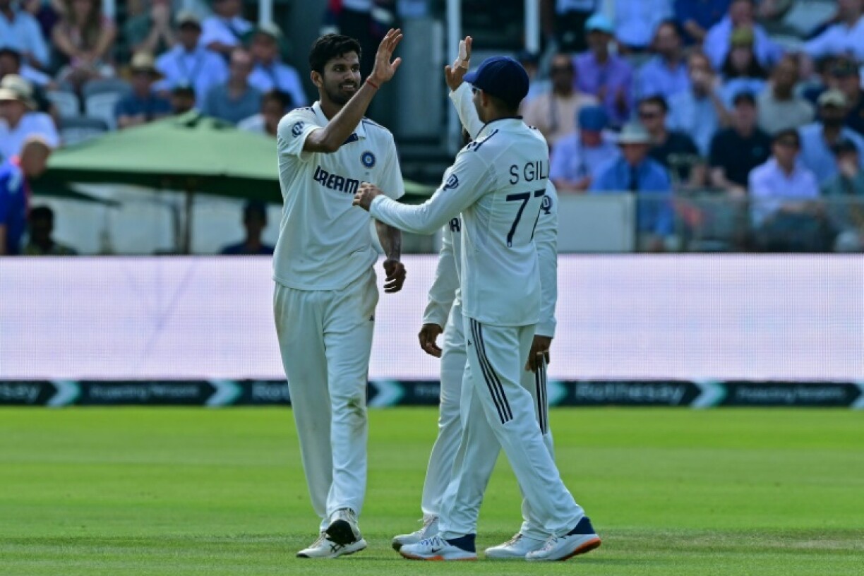 India's Washington Sundar (L) celebrates with team-mates after bowling England's Jamie Smith in the third Test at Lord's