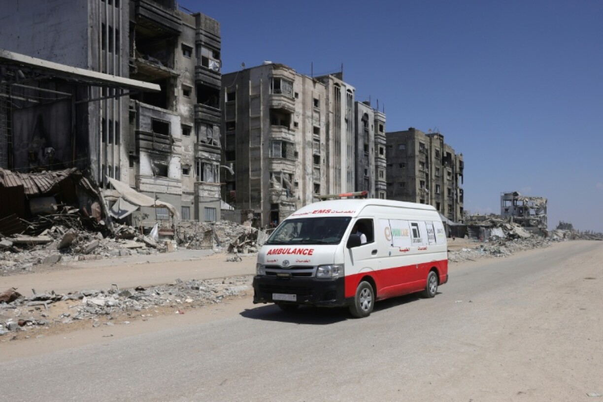 An ambulance drives past bombed out buildings in Jabalia in the northern Gaza Strip.