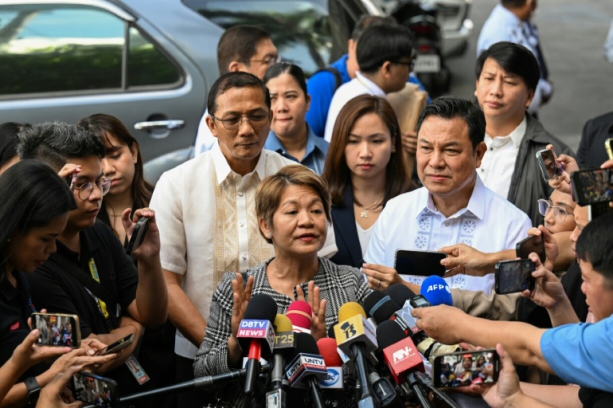 State prosecutor Olivia Torrevillas (C) talks to the media after securing life in prison for convicted trafficker Alice Guo