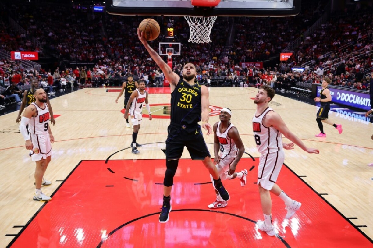 Golden State star Stephen Curry drives to the basket in the Warriors' NBA victory over the Houston Rockets