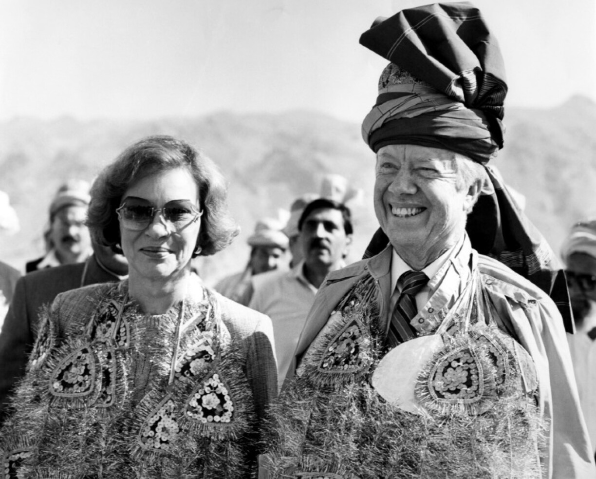 Former US president Jimmy Carter, accompanied by his wife Rosalynn, wears a pathan turban and glittering garlands presented by the Pakistani tribesmen at Michini Point on the Khyber Pass in November 1986