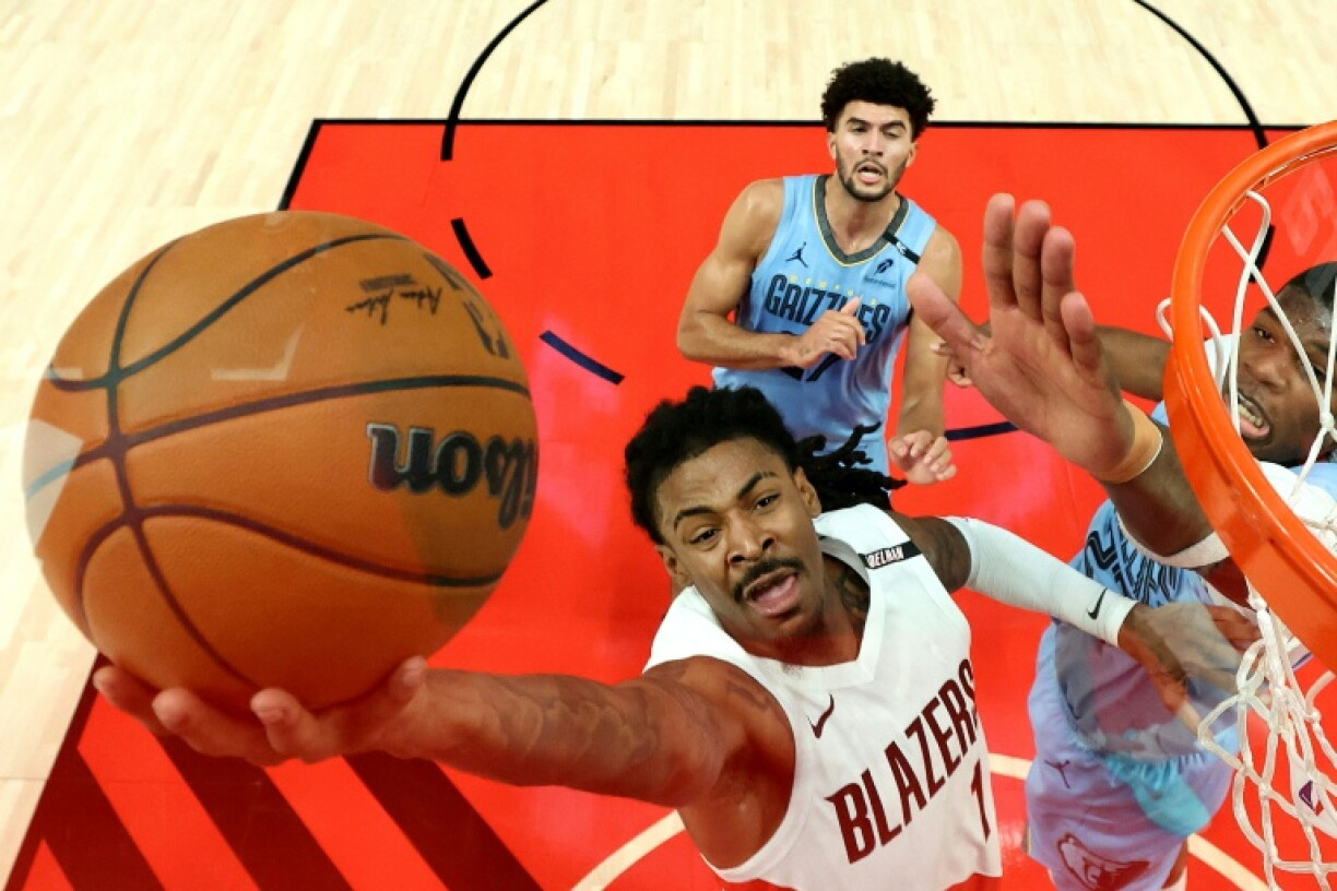 Portland's Ja Morant, driving to the basket against Memphis, will be out for the next four weeks after suffering a left hamstring injury, the NBA team announced