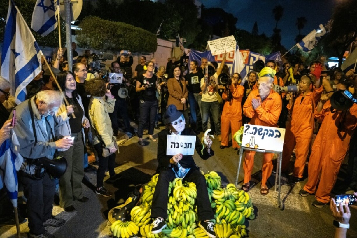People take part in a protest outside President Isaac Herzog's private home