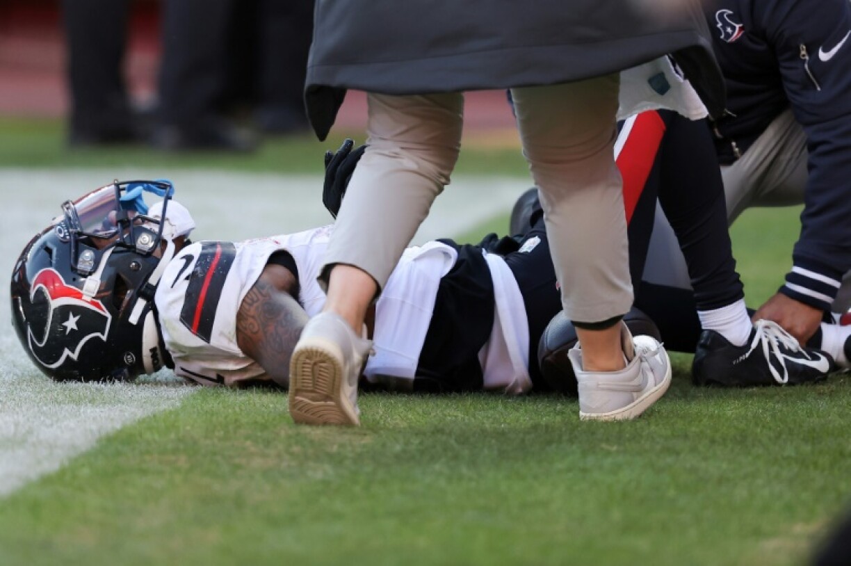 Medical staff look at Tank Dell of the Houston Texans after Dell sustained a severe leg injury while catching a touchdown in the third quarter of an NFL game at Kansas City