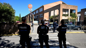 French municipal Police officers patrol outside the Joseph-Lakanal middle school after a headmaster was shot and wounded with a hunting rifle and a teenager was arrested in Aubagne, southern France on October 12, 2026.