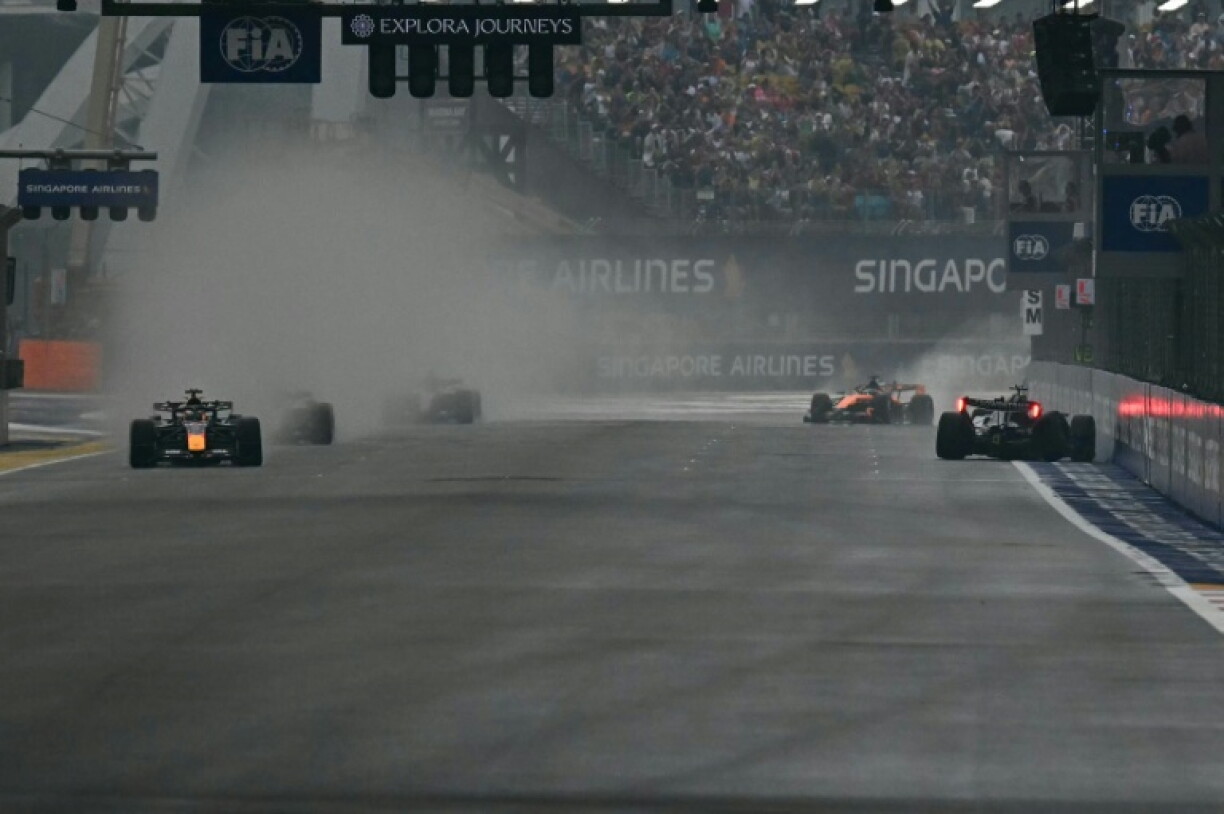 George Russell (right) crashes into the pit lane during the Singapore GP sprint race as Max Vertsappen (left) takes the lead