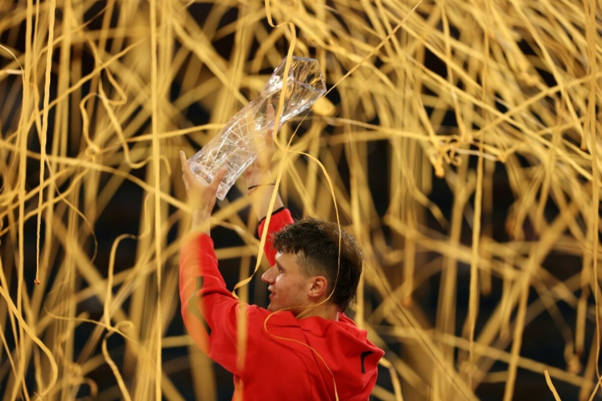Jakub Mensik of the Czech Republic lifts the championship trophy after defeating Novak Djokovic of Serbia in the Miami Open final.