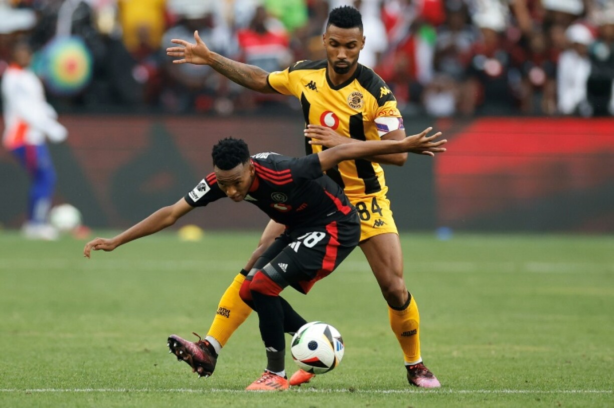 Orlando Pirates forward Relebohile Mofokeng (L) shields the ball from Kaizer Chiefs defender Inacio Miguel in a South African Premiership match.