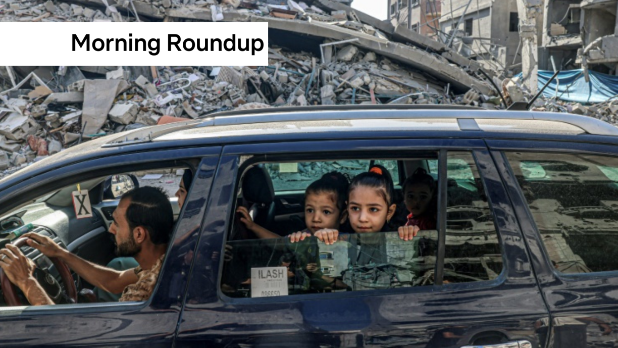 Palestinians drive amid the rubble of buildings destroyed in an Israeli air strike in Rafah, on the southern Gaza Strip