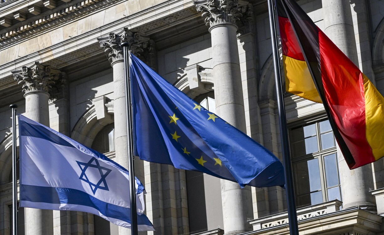 The flags of Israel, the EU and Germany fly in front of the Berlin House of Representatives on 13 October 2025.