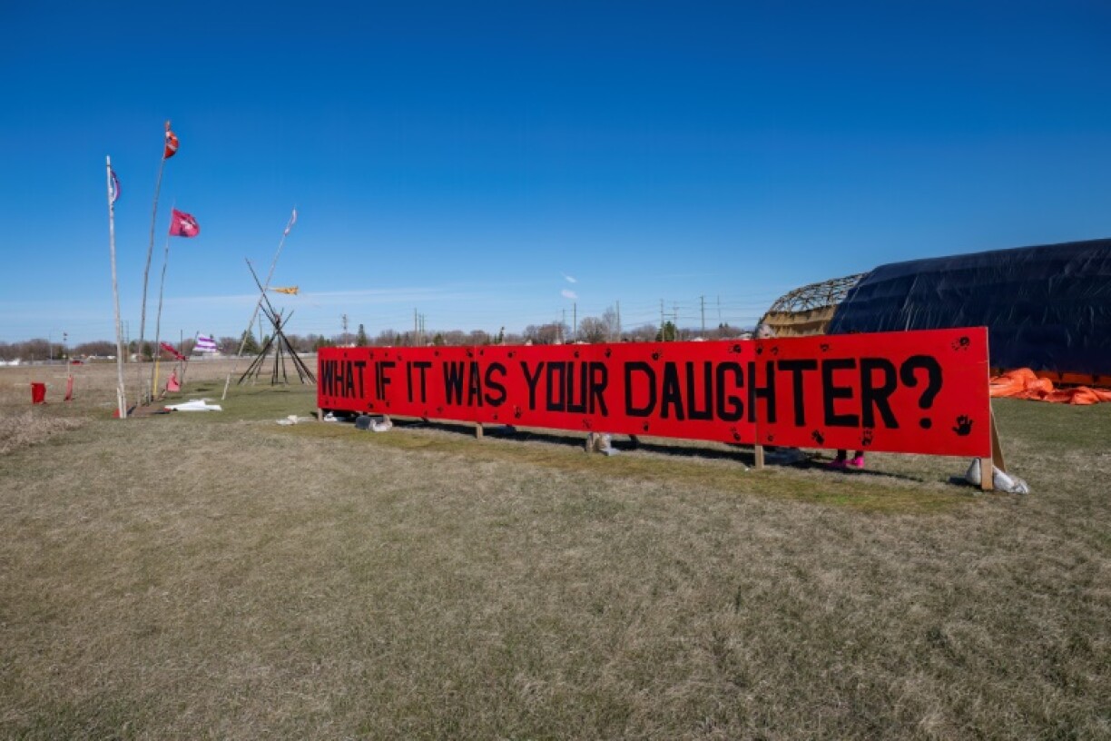 A sign is displayed at the entrance of a makeshift camp near near the Prairie Green landfill in Winnipeg in 2024
