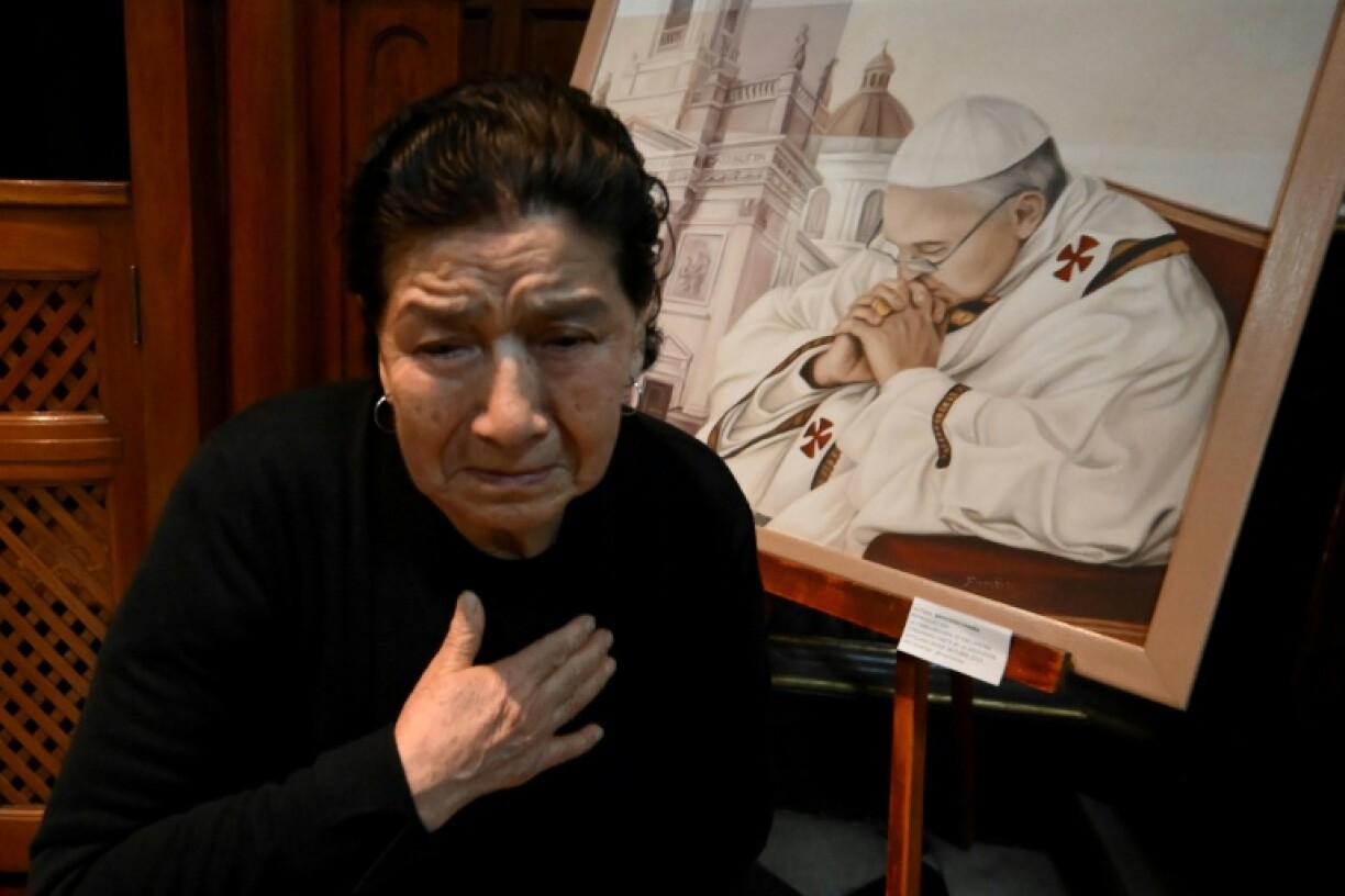 Mourners prayed in front of a painting depicting Pope Francis