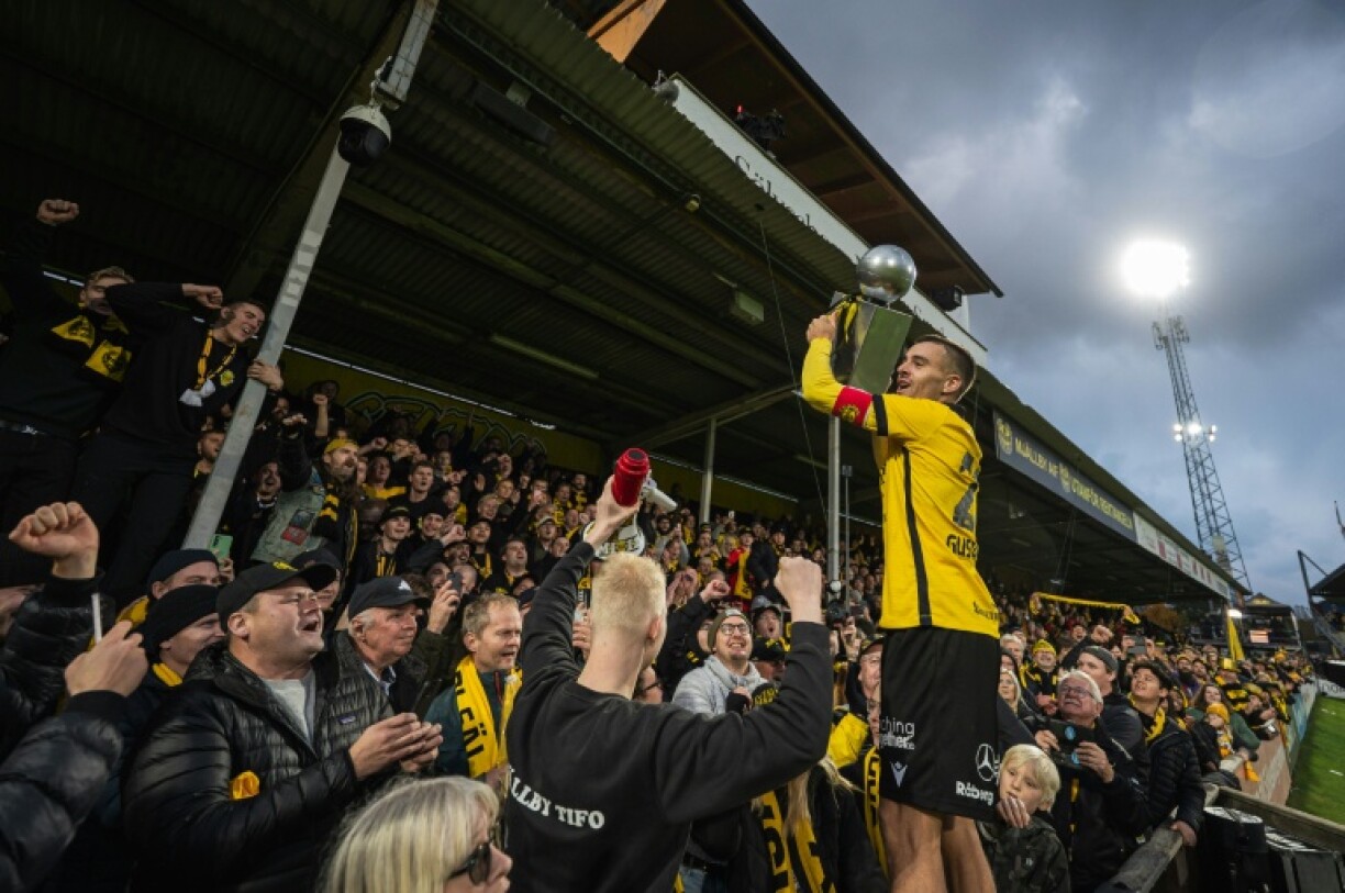 Mjallby captain Jesper Gustavsson basks in the party atmosphere at the club's 6,000-seat Strandvallen stadium