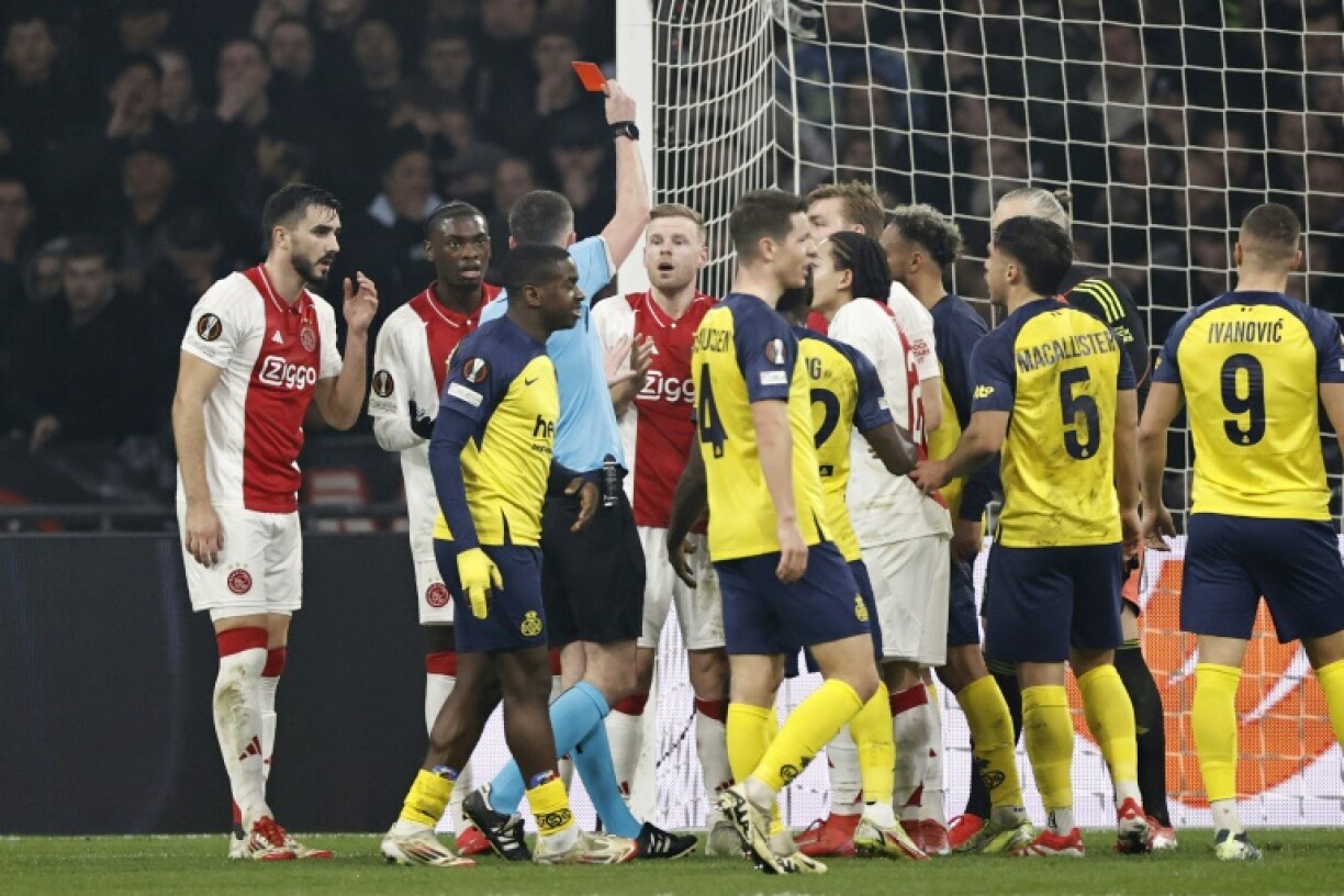 Davy Klaassen was sent off midway through the first half but Ajax battled their way into the last 16
