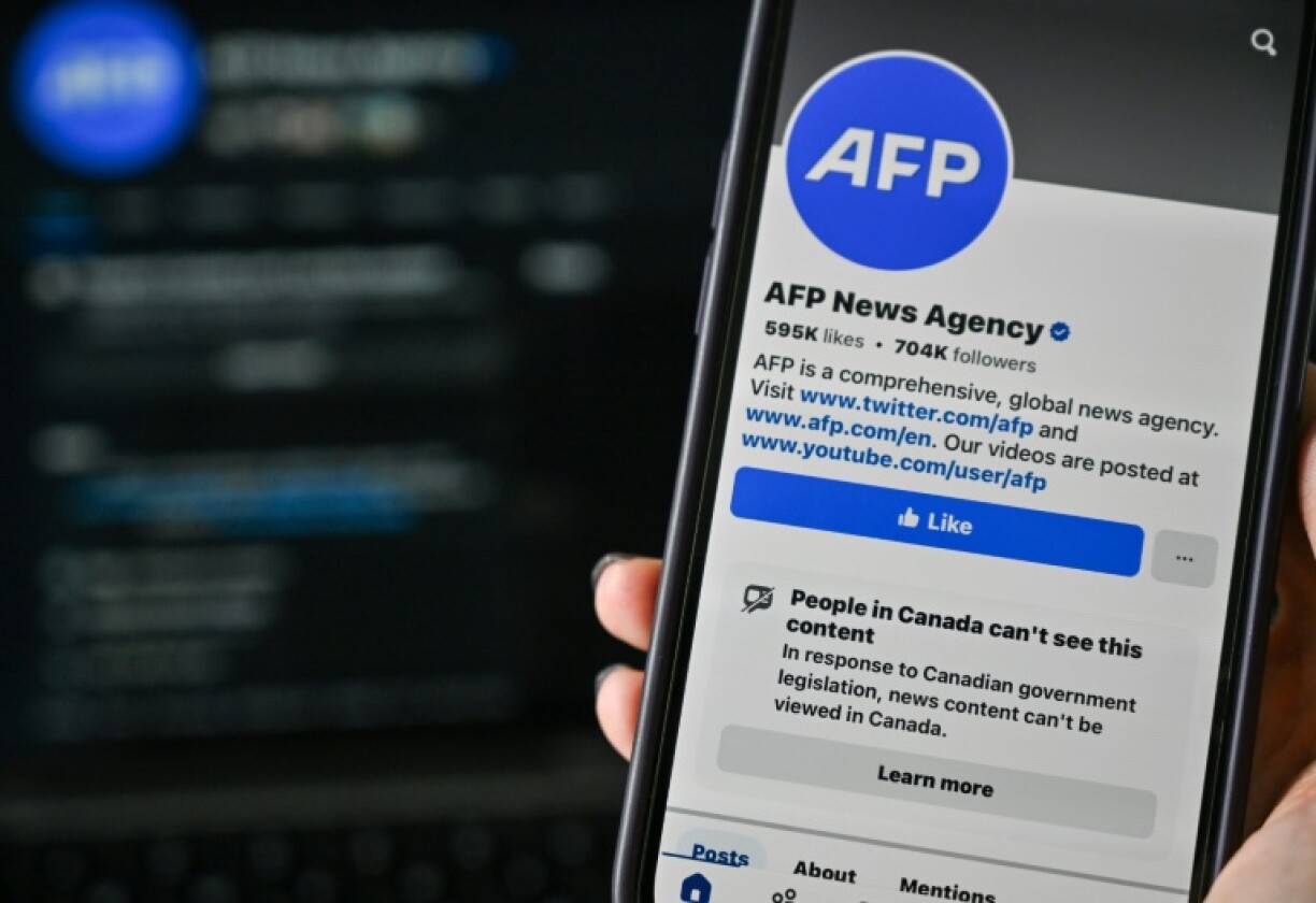This illustration photo taken on April 14, 2025, in Montreal, Canada, shows the alert: “People in Canada can’t see this content” on the Facebook page of news organization Agence France-Presse (AFP)
