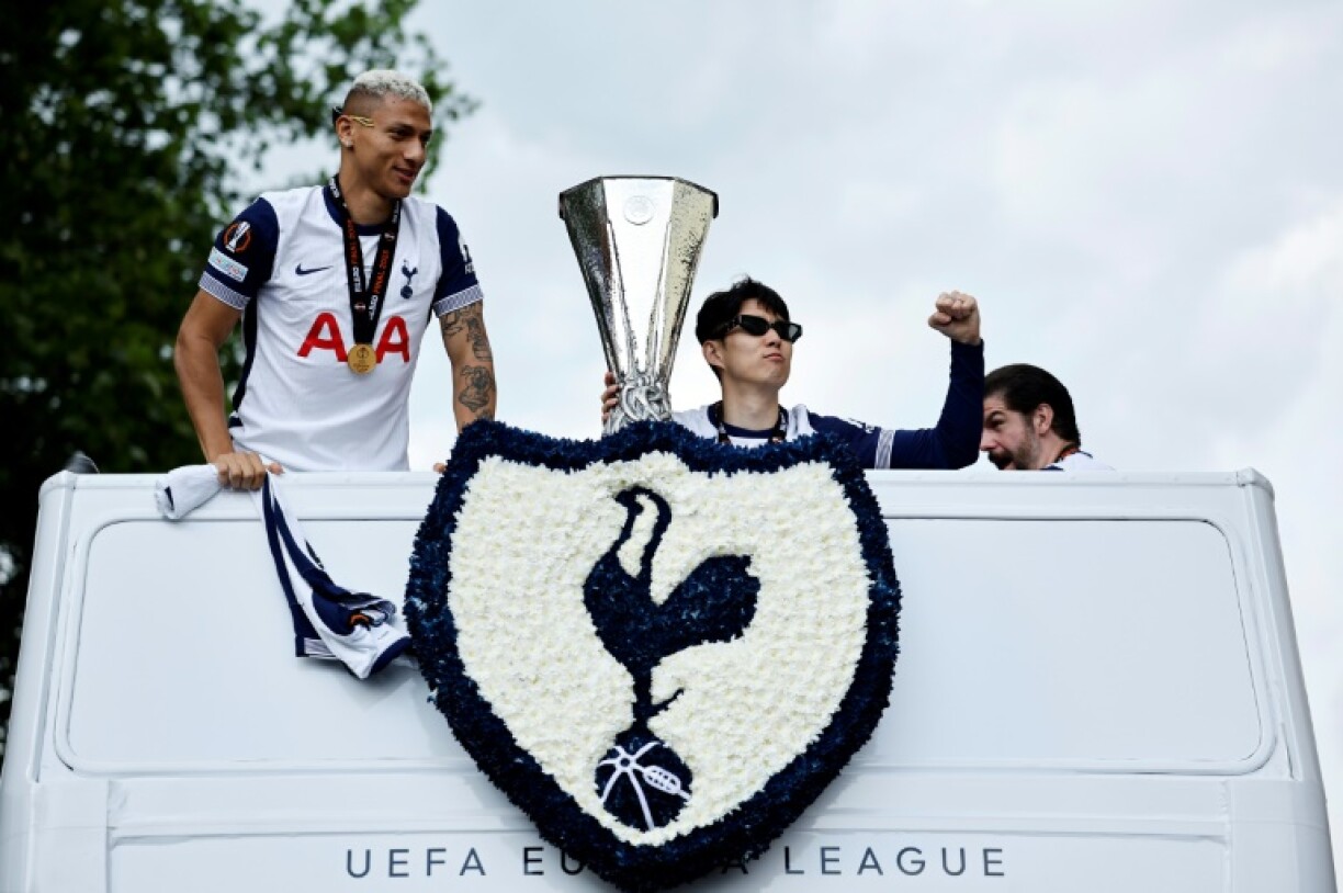 Tottenham's Son Heung-min holds the Europa League trophy during an open-top bus parade