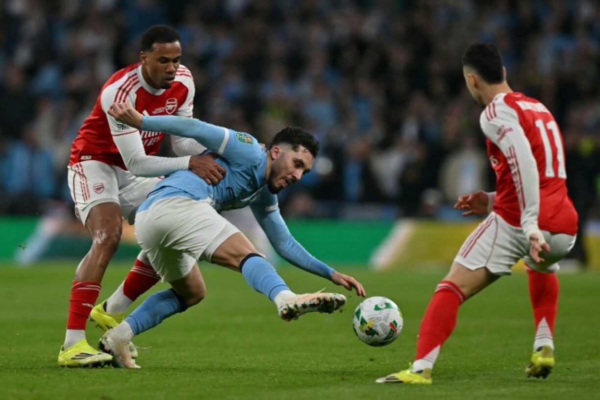 Le milieu offensif de Manchesr City Rayan Cherki au milieu de deux défenseurs d'Arsenal en finale de la Coupe de la ligue le 22 mars 2026 au stade de Wembley à Londres
