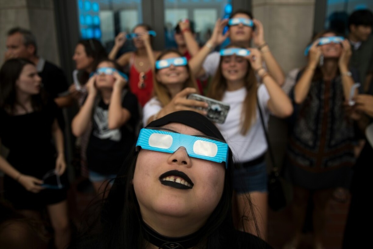 Observers wearing eye-protecting glasses to watch a solar eclipse in New York last year