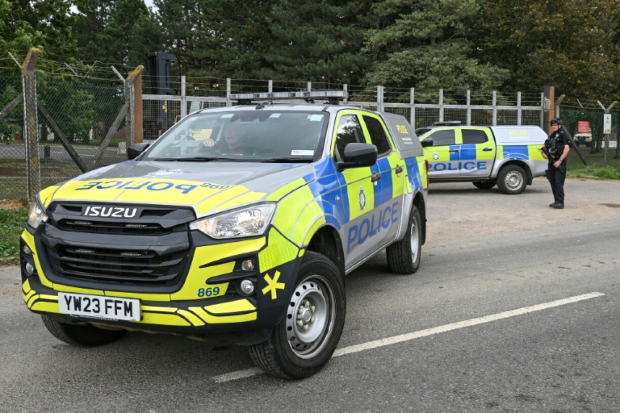 Armed police man a roadblock at an entrance to RAF Fairford base