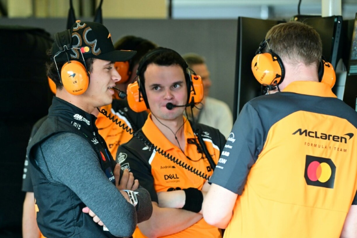 McLaren's British driver Lando Norris (L) admitted that he had taken responsibility for the opening lap crash with teammate Oscar Piastri