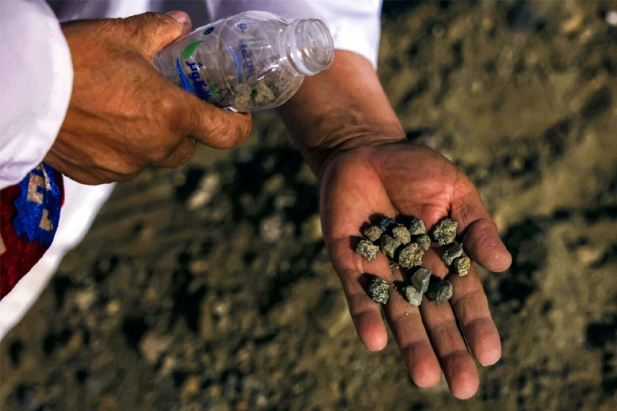 Muslim pilgrims throw seven stones at each of three concrete walls symbolising the devil in the Mina valley