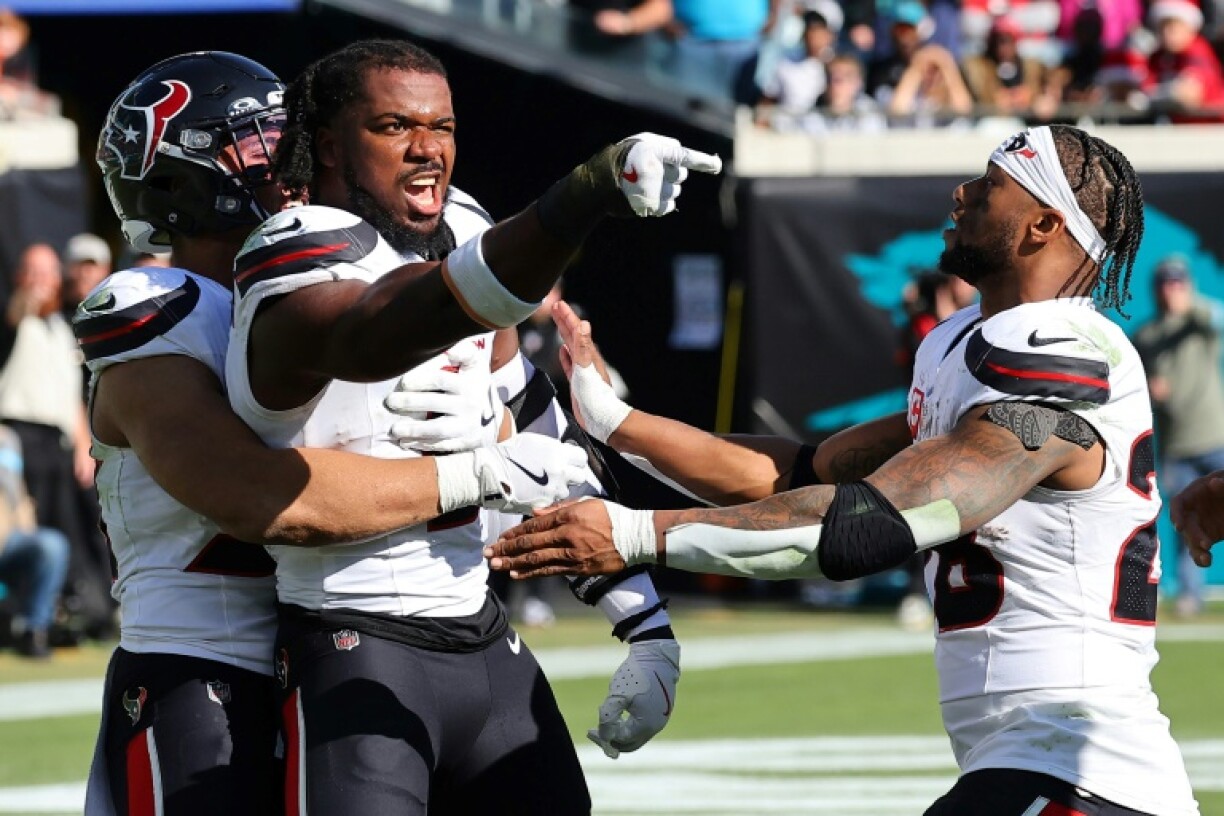Houston's Azeez Al-Shaair is restrained after being ejected from the Texans' NFL game against the Jacksonville Jaguars