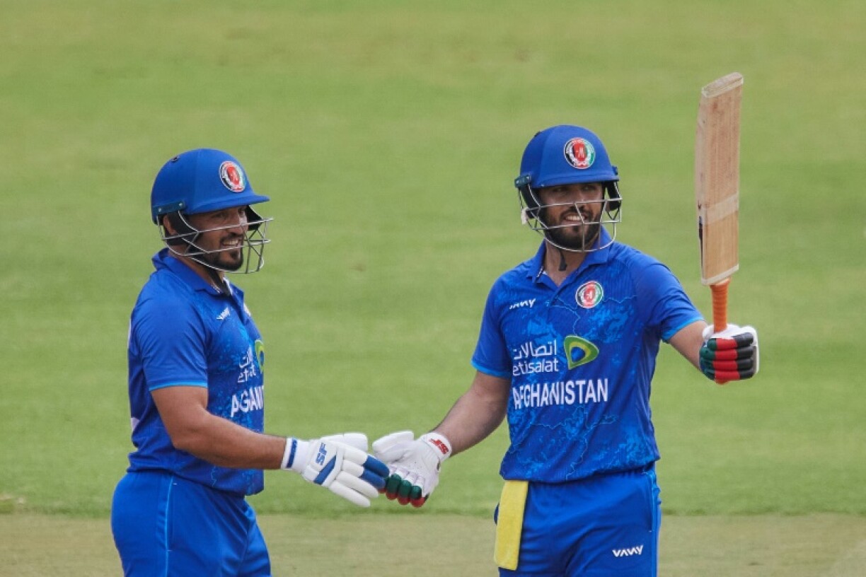 Darwish Rasooli (R) celebrates with Gulbadin Naib after scoring his first fifty for Afghanistan in a Twenty20 international against Zimbabwe in Harare on December 13.