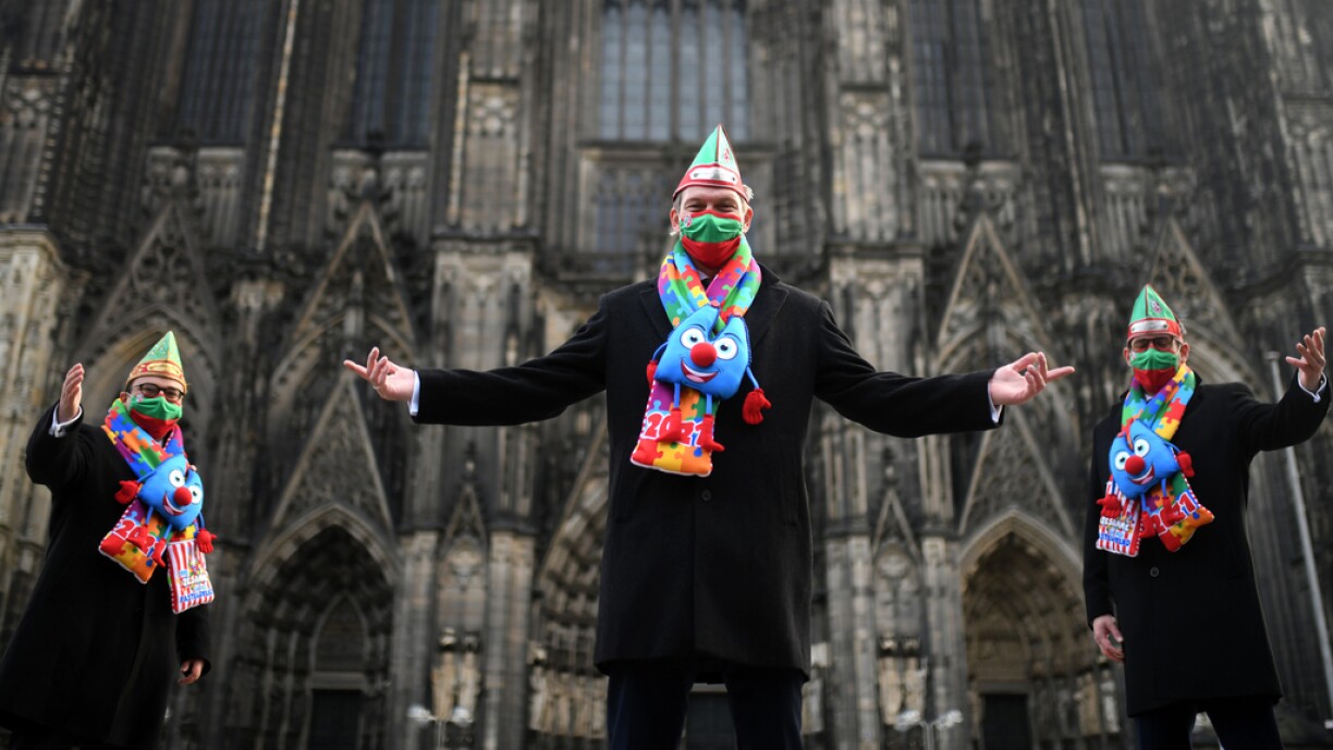 The members of the Cologne carnival triumvirate pose in front of the Cologne cathedral, western Germany, November 11, 2020. The carnival in Cologne starts usually at November 11, 11h11 but is cancelled due to the Corona Covid-19 pandemic.