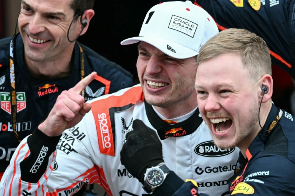 Max Verstappen (white cap) celebrates victory with his team members after the Japanese Grand Prix
