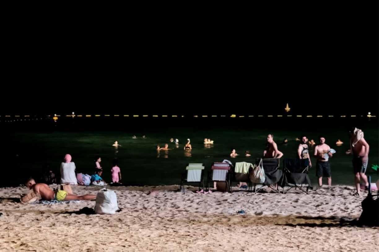 Dubai residents attempt to cool off at night at the Umm Suqeim beach as temperatures sizzle above 50 degrees Celsius (112 Fahrenheit)