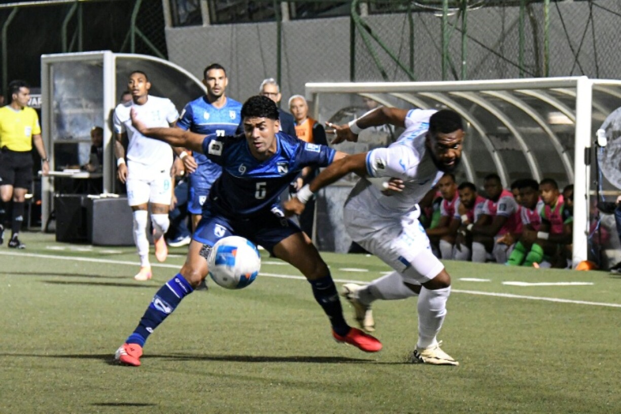 Nicaragua defender Justing Cano and Honduras forward Jorge Benguche fight for the ball during a CONCACAF 2026 World Cup qualifier
