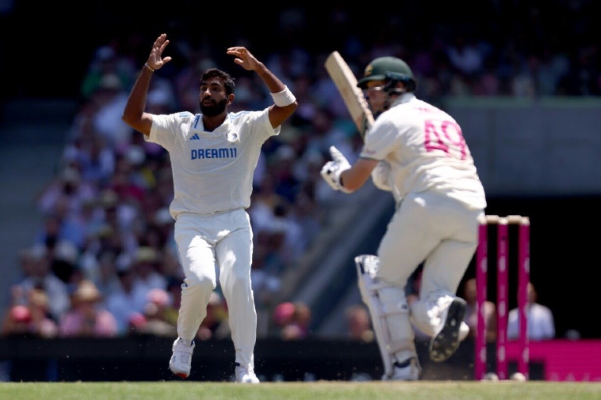 India’s captain Jasprit Bumrah (L) reacts after Australia’s Steve Smith hit a shot during day two of the fifth Test